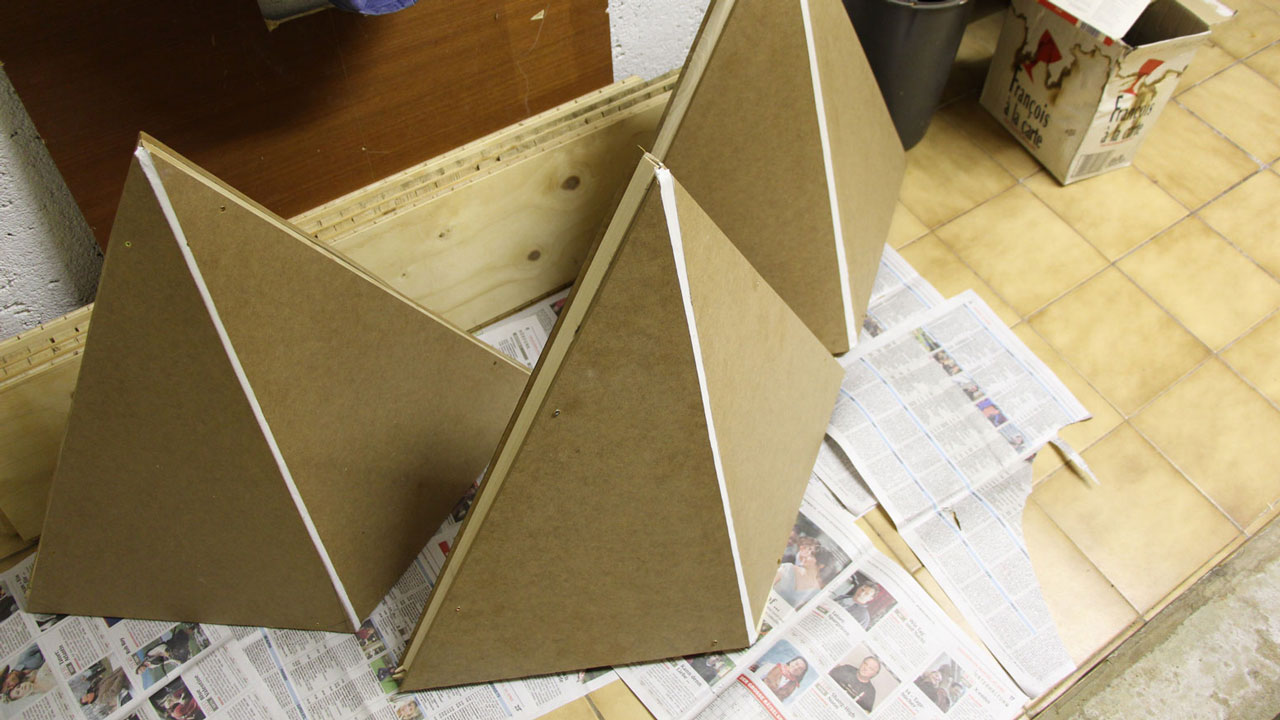 Wooden, unfinished tetrahedrons in workshop.