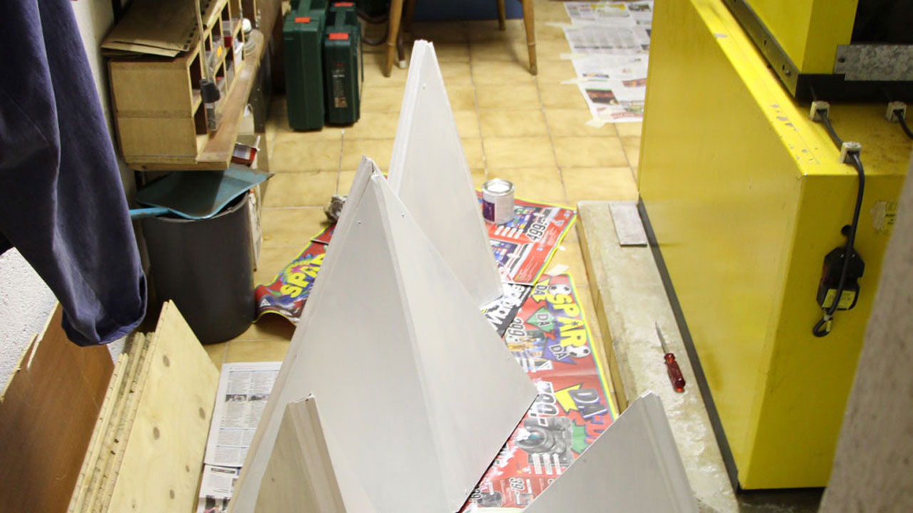 Wooden, white tetrahedrons in workshop.